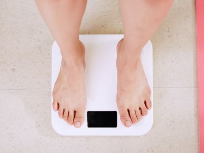 woman on a white weighing scale