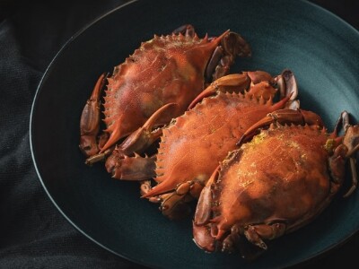 three crabs on a pan