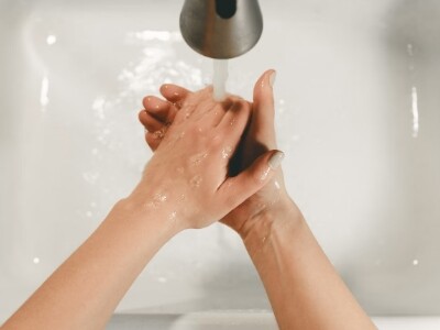 woman washing her hands on the sink